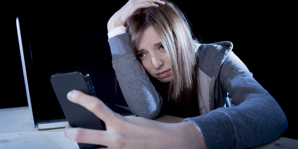 Woman receiving bullying text messages