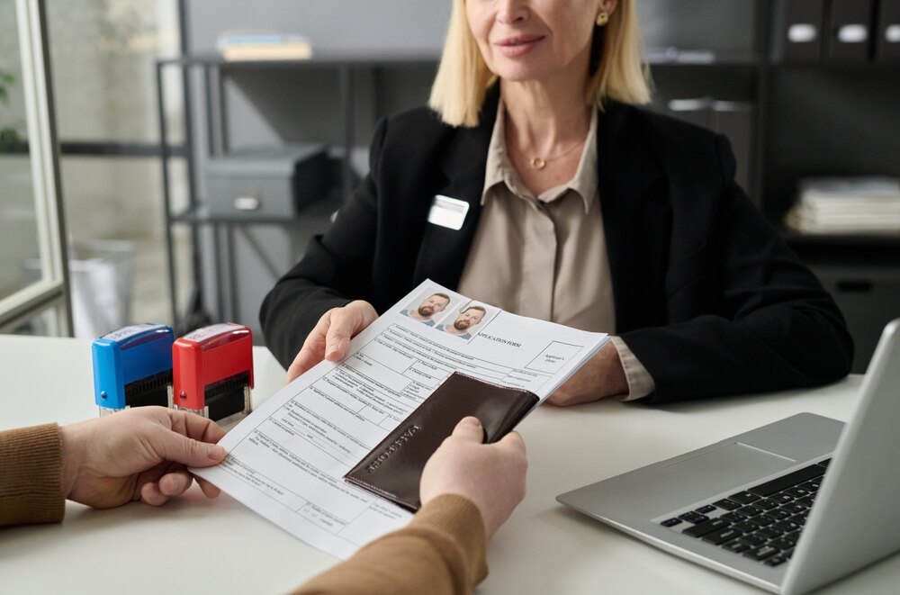 Passport and application documents being handed over for review