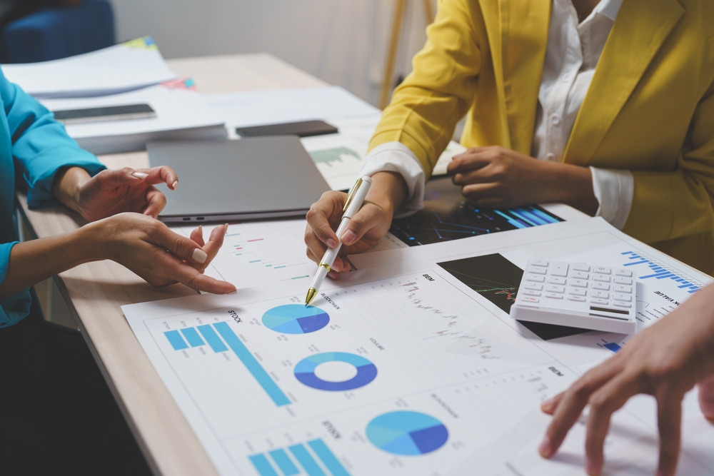 Professionals reviewing financial charts for an entrepreneur residence business plan in Spain